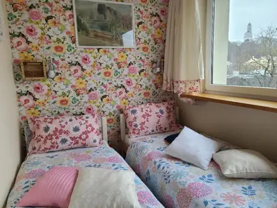 a small bedroom with a bed and a window at Center 04 in Kaunas