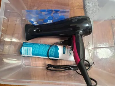 a blow dryer sitting on a table next to a toothbrush at Center 04 in Kaunas