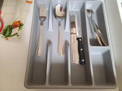 a tray with silver utensils on a table at Center 04 in Kaunas