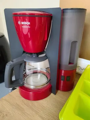 a red blender sitting on top of a table at Center 04 in Kaunas