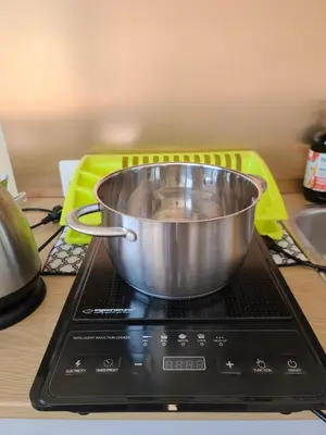 a metal bowl sitting on top of a stove at Center 04 in Kaunas