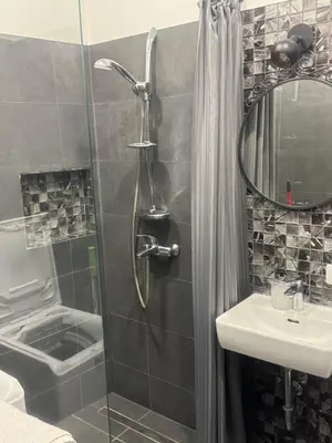 a bathroom with a shower and a sink at Modern city centre apartment in Vilnius