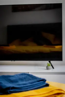 a flat screen tv sitting on top of a table at Ramūs apartamentai in Anykščiai