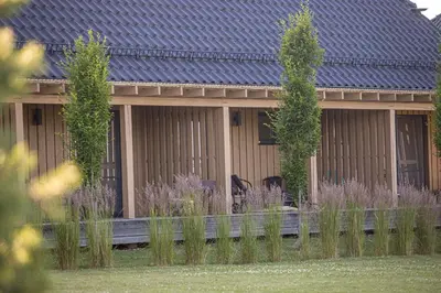 a house with a fence in front of it at Gradiali Anykščiai in Anykščiai