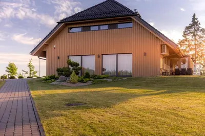 a house with a large yard in front of it at Gradiali Anykščiai in Anykščiai