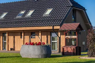 a house with a large basket of flowers in front of it at Gradiali Anykščiai in Anykščiai