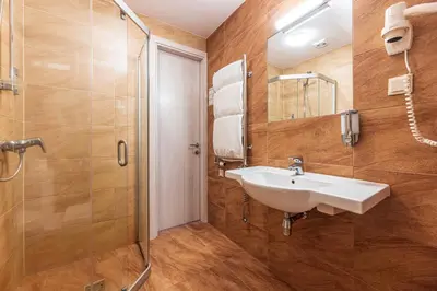 a bathroom with a sink and a shower at Gradiali Anykščiai in Anykščiai