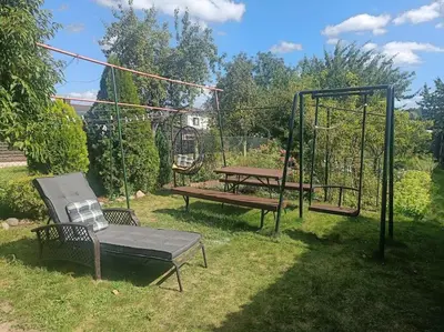 a park with two benches and a swing at Spacious Apartment Panemune in Kaunas