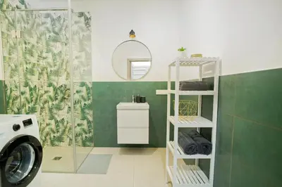 a bathroom with a washing machine and a shower at Central Station Apartment No1 in Kaunas