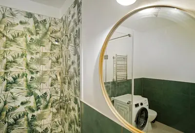 a bathroom with a mirror and a toilet at Central Station Apartment No1 in Kaunas