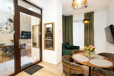 a living room with a table and a couch at Central Station Apartment No1 in Kaunas