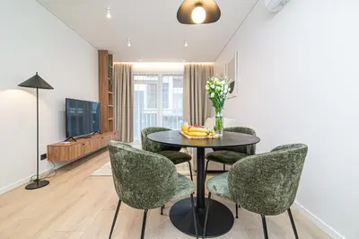 a dining room with a table and chairs at #stayhere - New & Stylish Minimalistic 1BDR Vilnius City Center in Vilnius