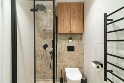 a bathroom with a shower with a toilet at #stayhere - New & Stylish Minimalistic 1BDR Vilnius City Center in Vilnius