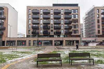 two benches in front of a large building at #stayhere - New & Stylish Minimalistic 1BDR Vilnius City Center in Vilnius