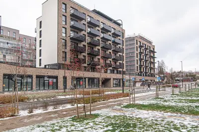 an apartment building in a city with snow on the ground at #stayhere - New & Stylish Minimalistic 1BDR Vilnius City Center in Vilnius