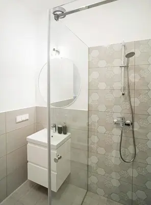 a bathroom with a shower with a toilet and a sink at Central Station Apartment No3 in Kaunas