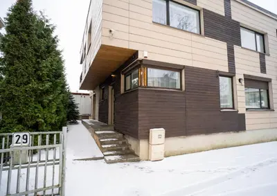 a house with a fence in front of it at Central Station Apartment No3 in Kaunas