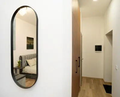 a mirror in the hallway of a house at Central Station Apartment No3 in Kaunas