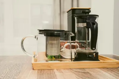 a coffee maker sitting on top of a wooden tray at Central Station Apartment No7 in Kaunas
