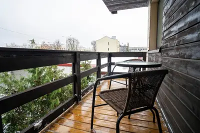 a balcony with two chairs and a table at Central Station Apartment No7 in Kaunas