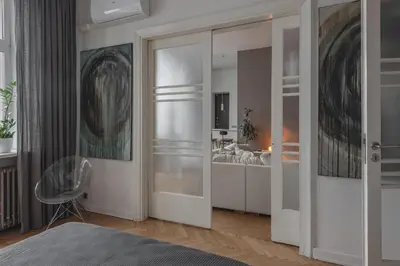 a bedroom with a large mirror and a bed at Apt-Gallery in Central Kaunas in Kaunas