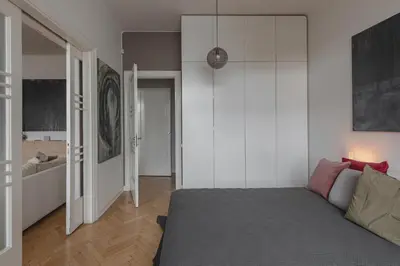 a living room with a bed and a couch at Apt-Gallery in Central Kaunas in Kaunas