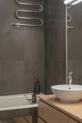 a bathroom with a white sink and a shower at Apt-Gallery in Central Kaunas in Kaunas