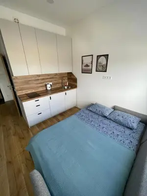 a bedroom with a bed and a sink at 25 Airport Apartment in Vilnius