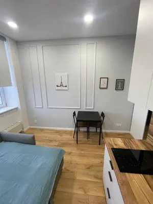 a living room with a table and a dining room at 25 Airport Apartment in Vilnius