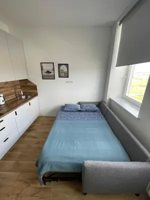 a small bedroom with a bed and a window at 25 Airport Apartment in Vilnius