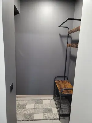 a room with a ladder and a shelf in a wall at Maironio apartamentai in Radviliškis