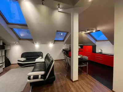 a living room with skylights in the ceiling at Apartamentai prie Seimo in Vilnius