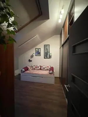 a bedroom with a couch in a room at Apartamentai prie Seimo in Vilnius