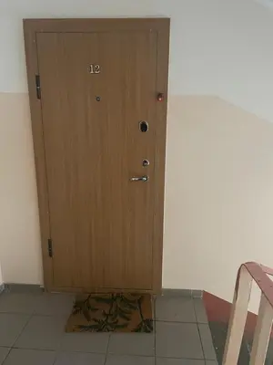 a wooden door in the corner of a room at Apartment in Šiauliai in Šiauliai