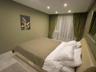 a bedroom with a bed and a window at Apartment in Šiauliai in Šiauliai