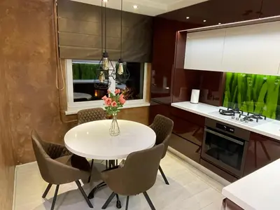 a kitchen with a white dining room table and chairs at Apartment in Šiauliai in Šiauliai