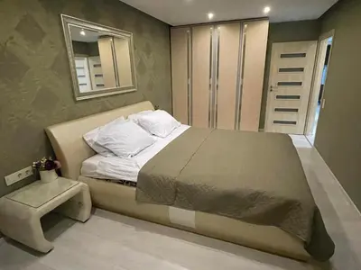 a bedroom with a large bed and a window at Apartment in Šiauliai in Šiauliai