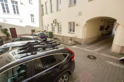 a car parked in a parking lot next to a building at Historic Central Apartment in Vilnius