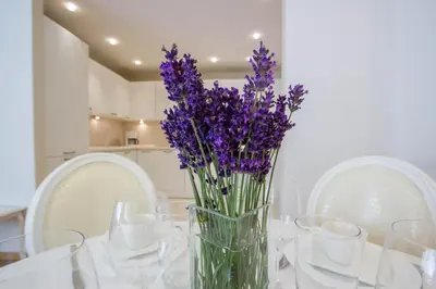 a vase filled with purple flowers sitting on a table at Historic Central Apartment in Vilnius