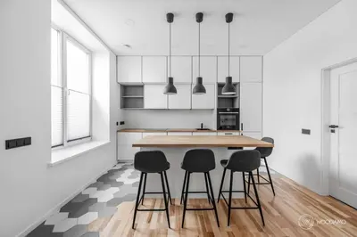 a kitchen with a wooden table and four chairs at Stylish apartment in city center in Vilnius
