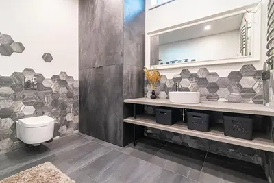 a bathroom with a toilet and a sink at Stylish apartment in city center in Vilnius