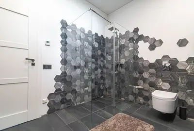 a bathroom with a shower and a toilet at Stylish apartment in city center in Vilnius