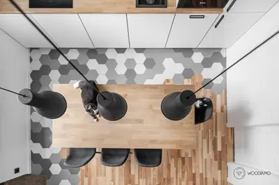 a cat sitting on a wooden bench in a kitchen at Stylish apartment in city center in Vilnius