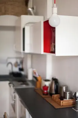 a kitchen with white cabinets and a counter top at #stayhere - Stylish Studio Close to Old Town in Vilnius
