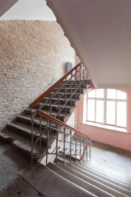 a staircase in an old building with a window at #stayhere - Stylish Studio Close to Old Town in Vilnius