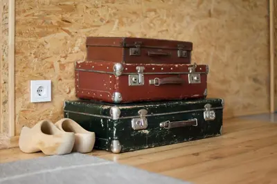 four suitcases stacked on top of each other on a floor at #stayhere - Stylish Studio Close to Old Town in Vilnius