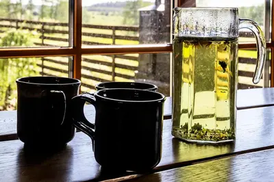 two cups of tea sitting on a table next to a window at Barškulių Sodyba in Ricieliai