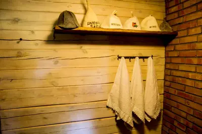 a bathroom with towels hanging on a wall at Barškulių Sodyba in Ricieliai
