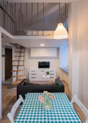 a living room with a couch and a table at Kauno Mini Loft by Lollo Stay in Vilnius