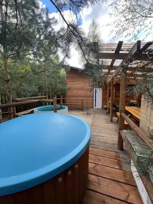 a wooden deck with a hot tub in a yard at Pasakų pirtelė in Vilnius